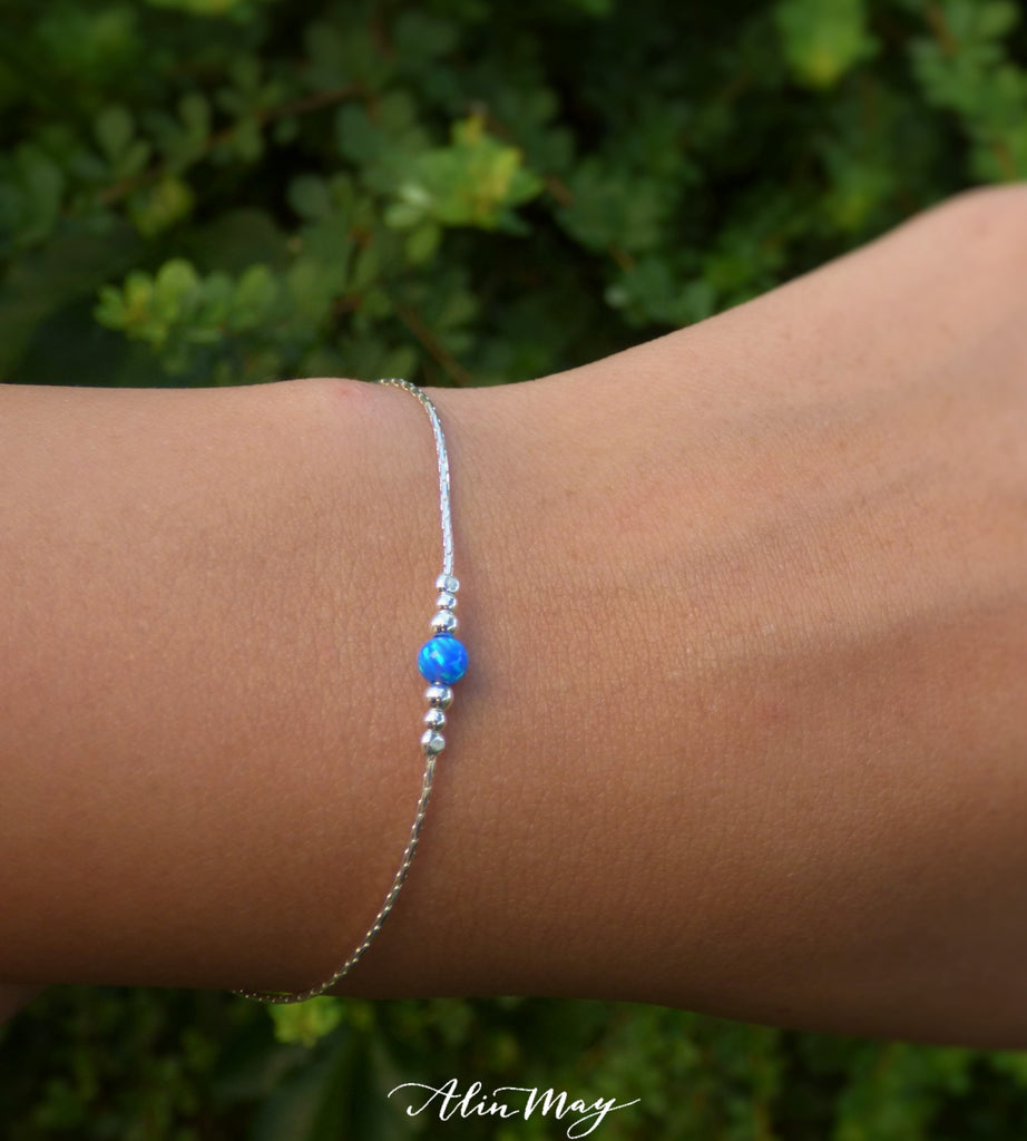 A woman is wearing sterling Silver bracelet with a Blue Opal bead and little silver beads-AlinMay