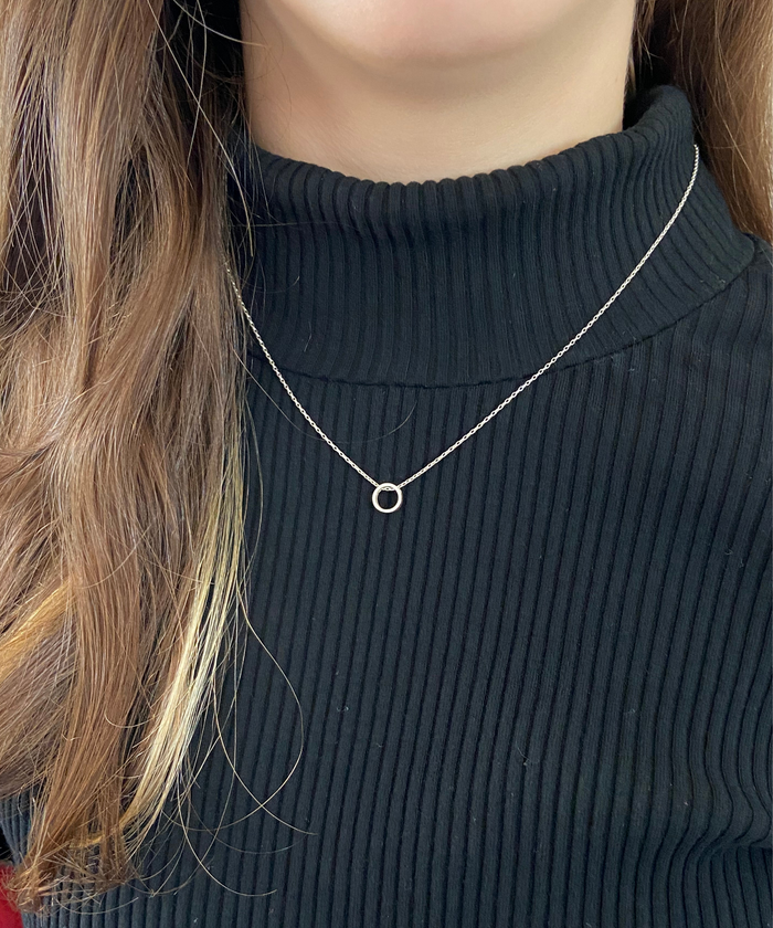 A model wearing a Karma Circle Necklace in sterling silver, featuring a delicate and small circle pendant in smooth finish on a Cable sterling silver chain-AlinMay
