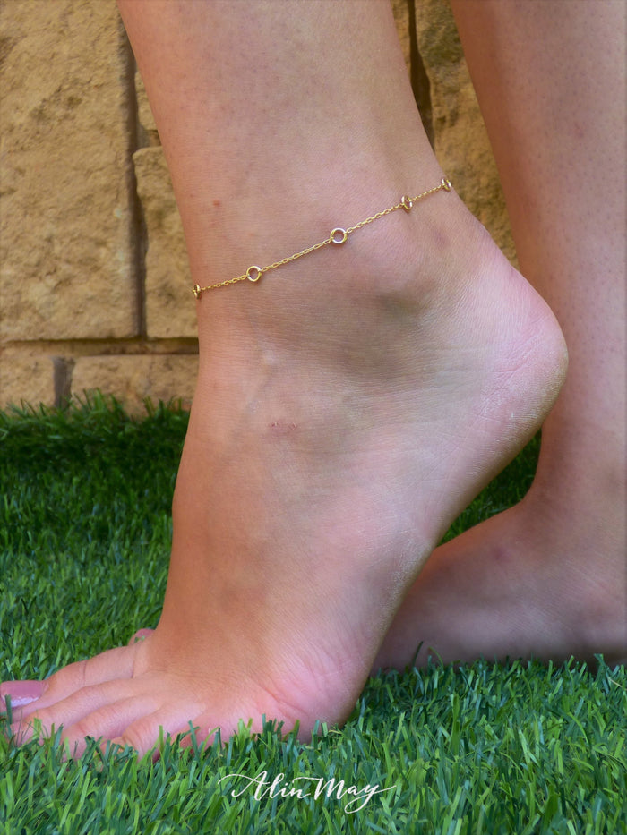 A woman is wearing a gold filled Ankle bracelet with a tiny circles-AlinMay