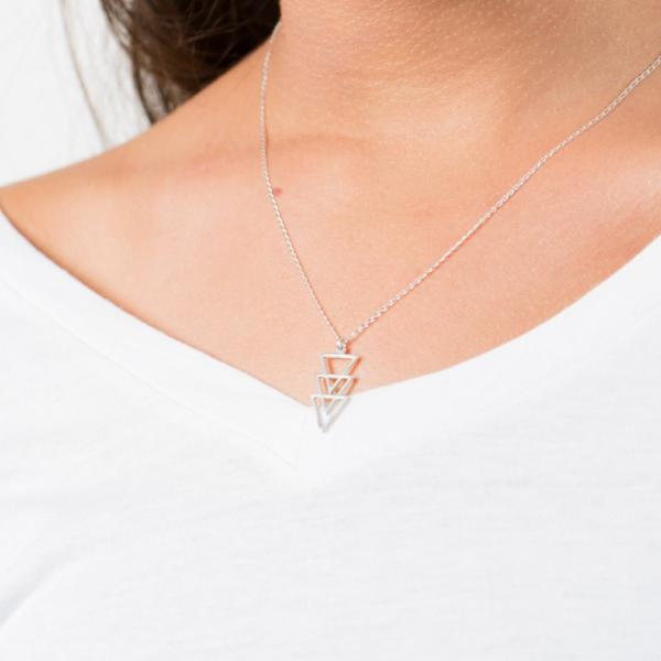 The woman is wearing minimal Sterling Silver necklace with a geometric triangle pointing down-AlinMay