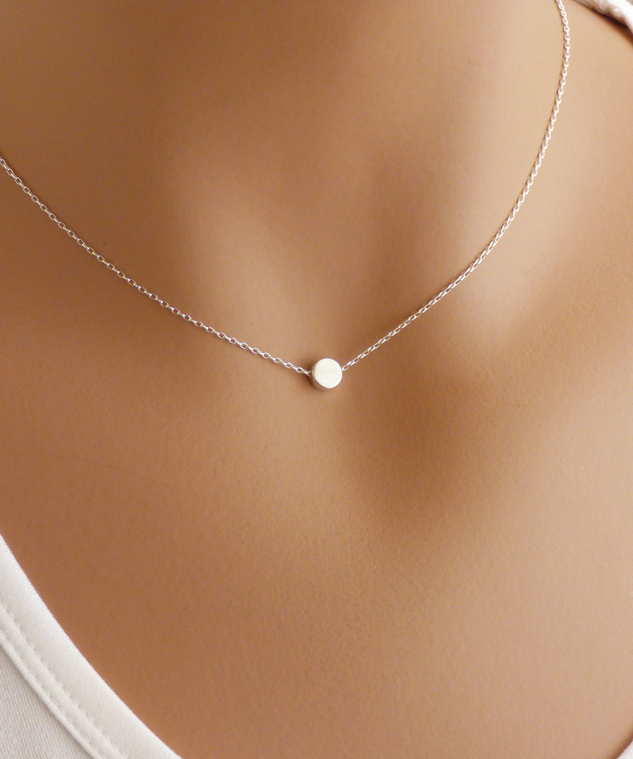 Stylish and elegant sterling silver necklace with a dot charm in a smooth finish, perfect for adding a touch of sophistication to any outfit.