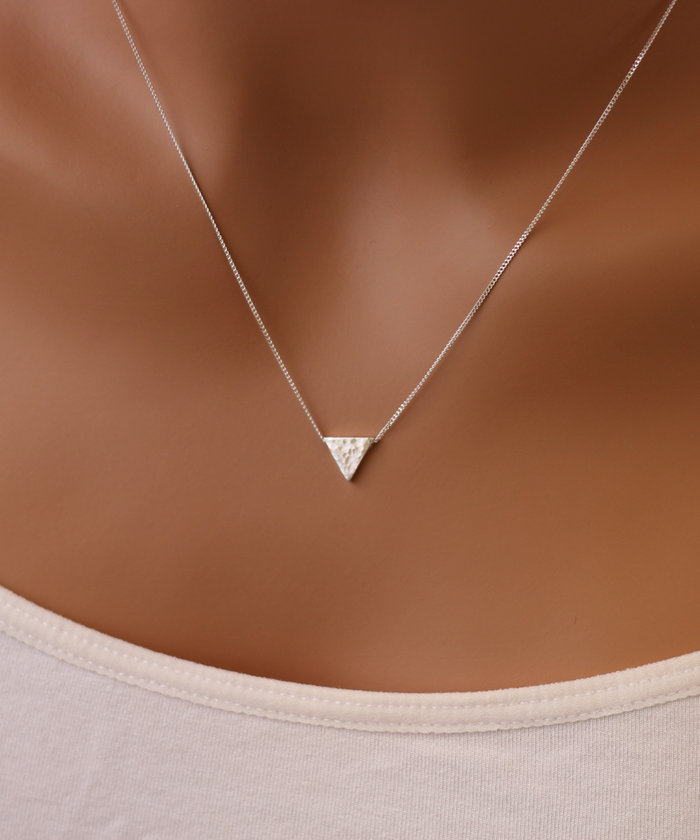 A model wearing a sterling silver hammered triangle necklace with a unique textured pendant,  on a delicate Curb chain-AlinMay