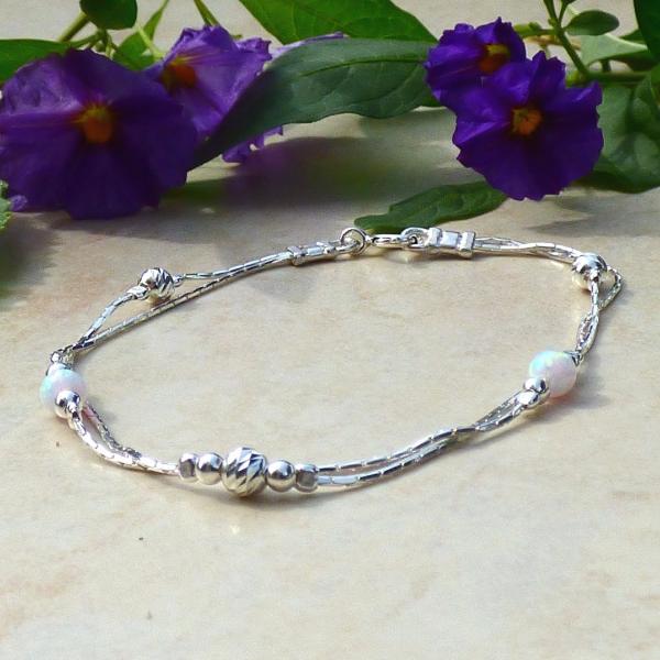 Silver layered bracelet with a white opals beads.