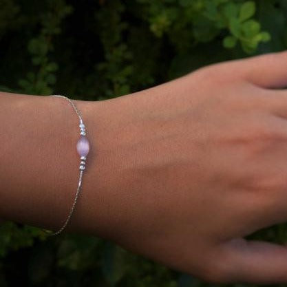 A woman is wearing a Silver bracelet with a Purple oval bead-AlinMay
