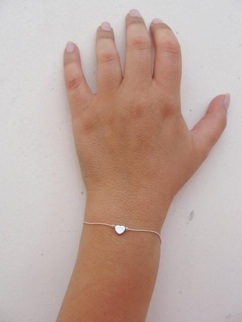 A woman is wearing Silver Bracelet with tiny heart-AlinMay