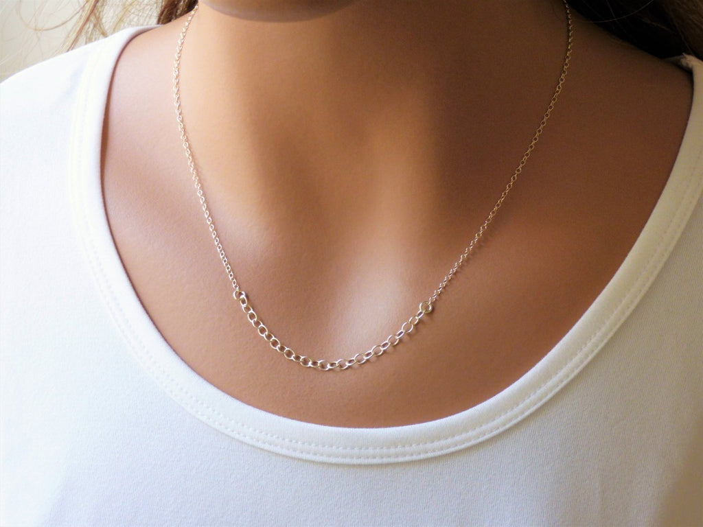 A woman is wearing a minimalist Silver necklace with a tiny circles-AlinMay