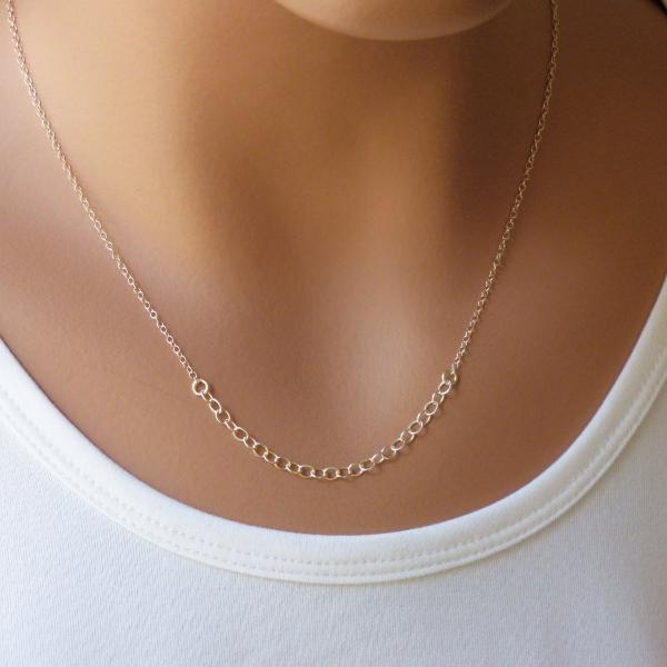A woman is wearing a simple Silver necklace with a tiny circles-AlinMay